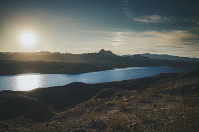 Scenic view of lake against sky during sunset