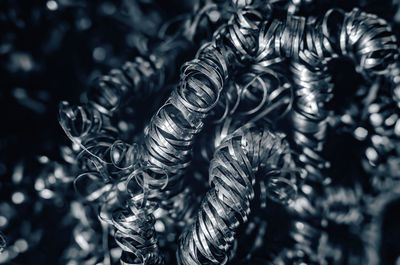 Iron metal shavings, curls, gray metal background. macro shooting of metal processing