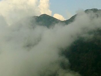 Scenic view of mountains against cloudy sky