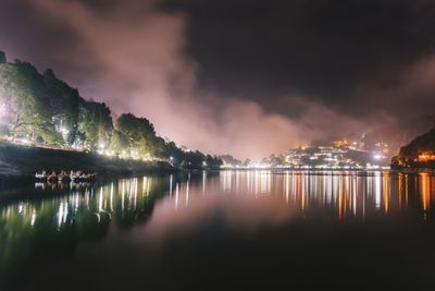 Scenic view of lake against sky at night