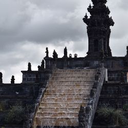 Low angle view of old ruin against cloudy sky