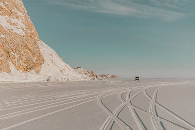 Scenic view of frozen lake against sky during winter