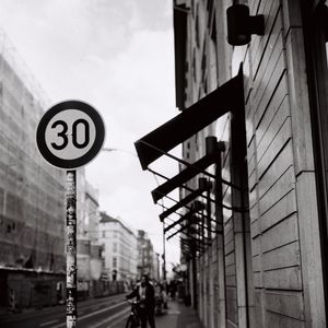 Low angle view of road sign against sky