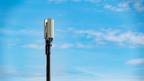 Low angle view of communications tower against sky