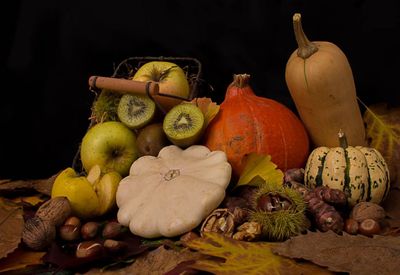 Close-up of pumpkins on table against black background