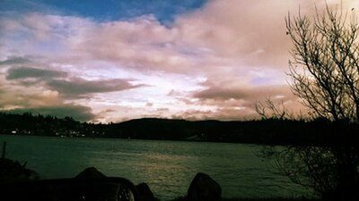 Scenic view of lake against cloudy sky