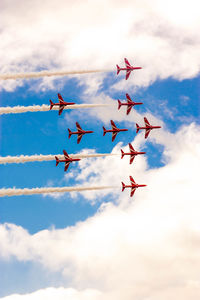 Low angle view of airshow against sky