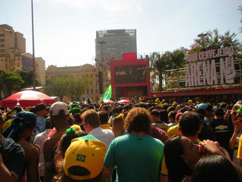 People on street in city against sky