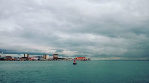 Scenic view of sea against cloudy sky