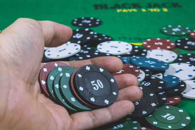 Cropped hand holding gambling chips