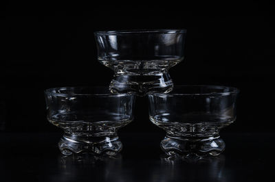 Close-up of glass bowls against black background