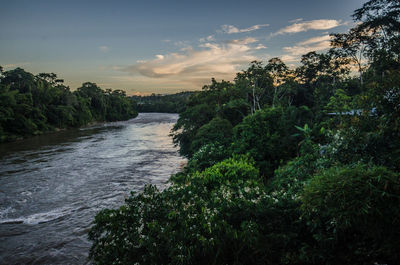 Scenic view of river against sky at sunset