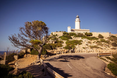 Trees and lighthouse against sky, cap formentor