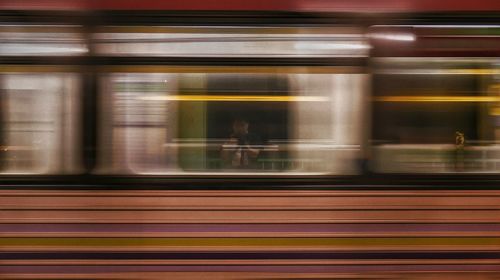 Blurred motion of train at railroad station