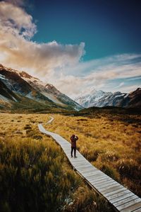 Full length of man standing on mountain against sky