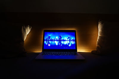 Low angle view of illuminated text on wall at night