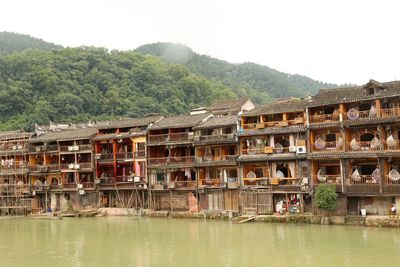 View of buildings against mountain and sky