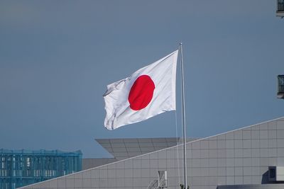 Low angle view of japanese flag against clear sky