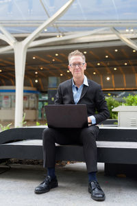 Portrait of man sitting on seat