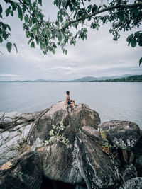 Man looking at sea against sky