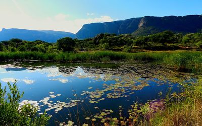 Scenic view of lake and mountains against sky