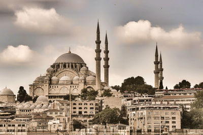 View of buildings in city against sky