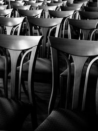 Empty chairs and table in row