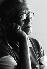 Thoughtful senior man with hand on chin