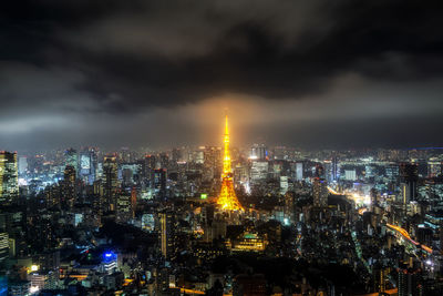 Illuminated cityscape against sky at night