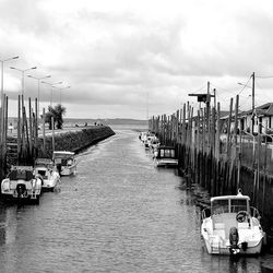 Pier on sea against cloudy sky