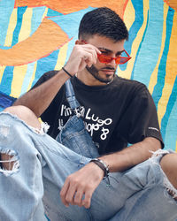 Portrait of young man sitting in tent