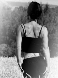 Rear view of woman standing on land