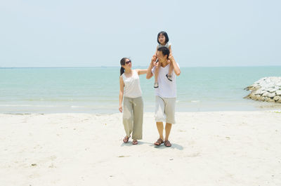 Full length of woman on beach against clear sky