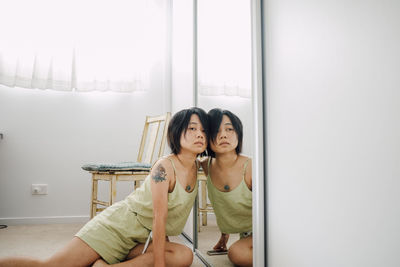 Portrait of smiling mother and daughter at home