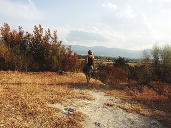 Full length of man standing on landscape against sky