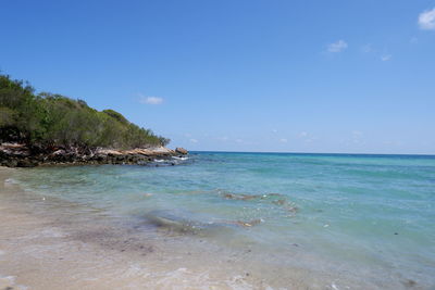 Scenic view of sea against blue sky