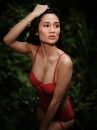 Portraiture shot of a beautiful asian female model in bikini at a river