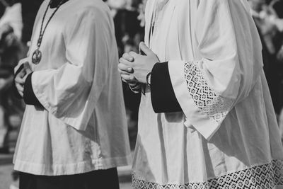 Midsection of women standing on cross