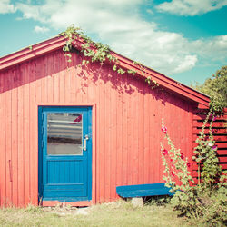 Red building against cloudy sky