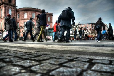 People on street in city against sky