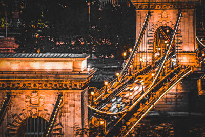 Illuminated bridge against sky at night