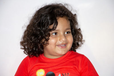 Portrait of smiling girl against white background