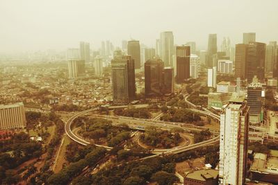 High angle view of modern buildings in city against sky