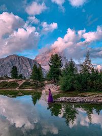 Scenic view of lake by trees against sky