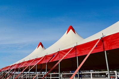 Low angle view of tent against blue sky