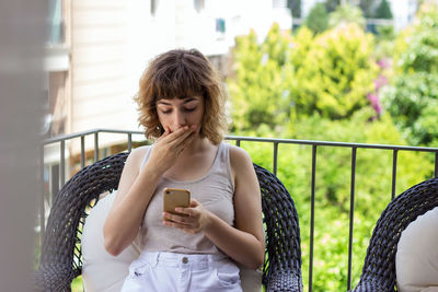 Portrait of young woman using mobile phone