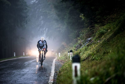 Man riding bicycle on road