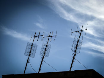 Low angle view of communications tower against sky