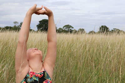 Close up of a girl sitting in tall grass