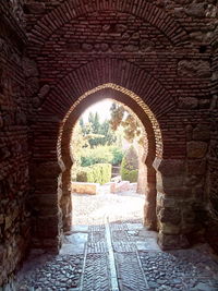 Archway leading to brick wall